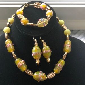 One of a kind set with green gemstones and gold.